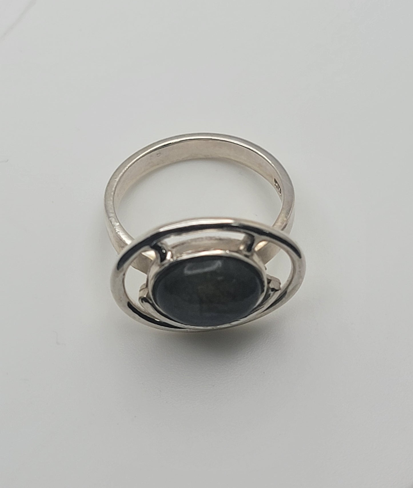 Close-up view of the Labradorite Ring 925 Sterling Silver Statement Ring resting on a white background. This piece is a must-have for anyone looking for casual jewelry, making it a thoughtful Gift for Her or Gift for Him. The ring stands out as a beautiful statement ring in polished Sterling Silver.