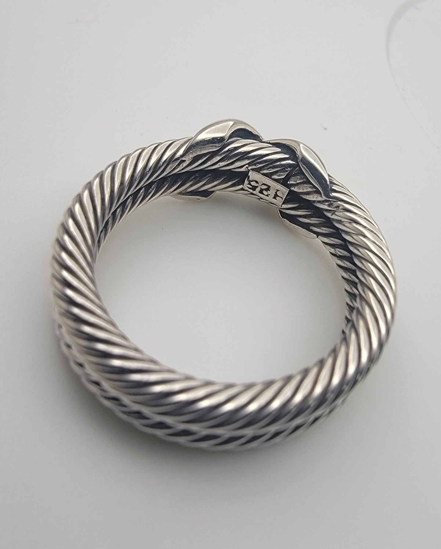 Side view of the 925 Sterling Silver Double Twist Rope Ring highlighting the sleek polished crossover detail.