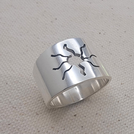 Close-up view of the 925 Sterling Silver Wideband Sunburst Ring showcasing its striking sun cutout design on a bold silver band. This artisan jewelry piece is perfect for casual wear, adding a modern touch to your summer jewelry collection with its unique silver ring style.