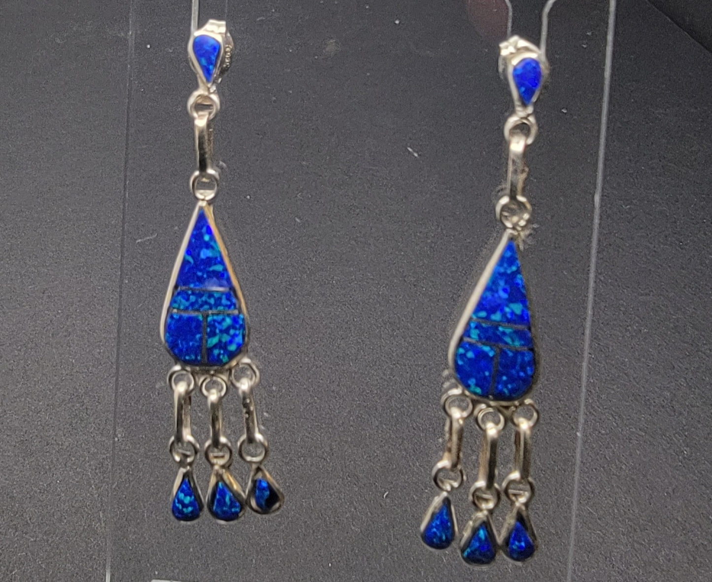 Handcrafted opal inlay dangle earrings showcasing stunning blue opal in a teardrop design.