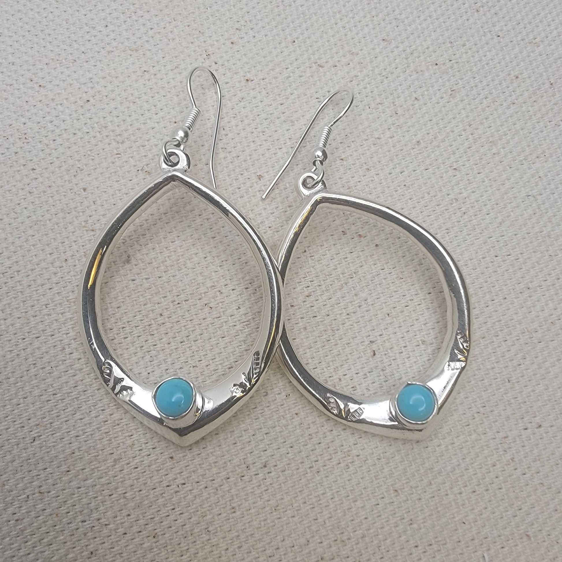 Teardrop Sterling Silver Earring with Turquoise Cabochon on neutral background