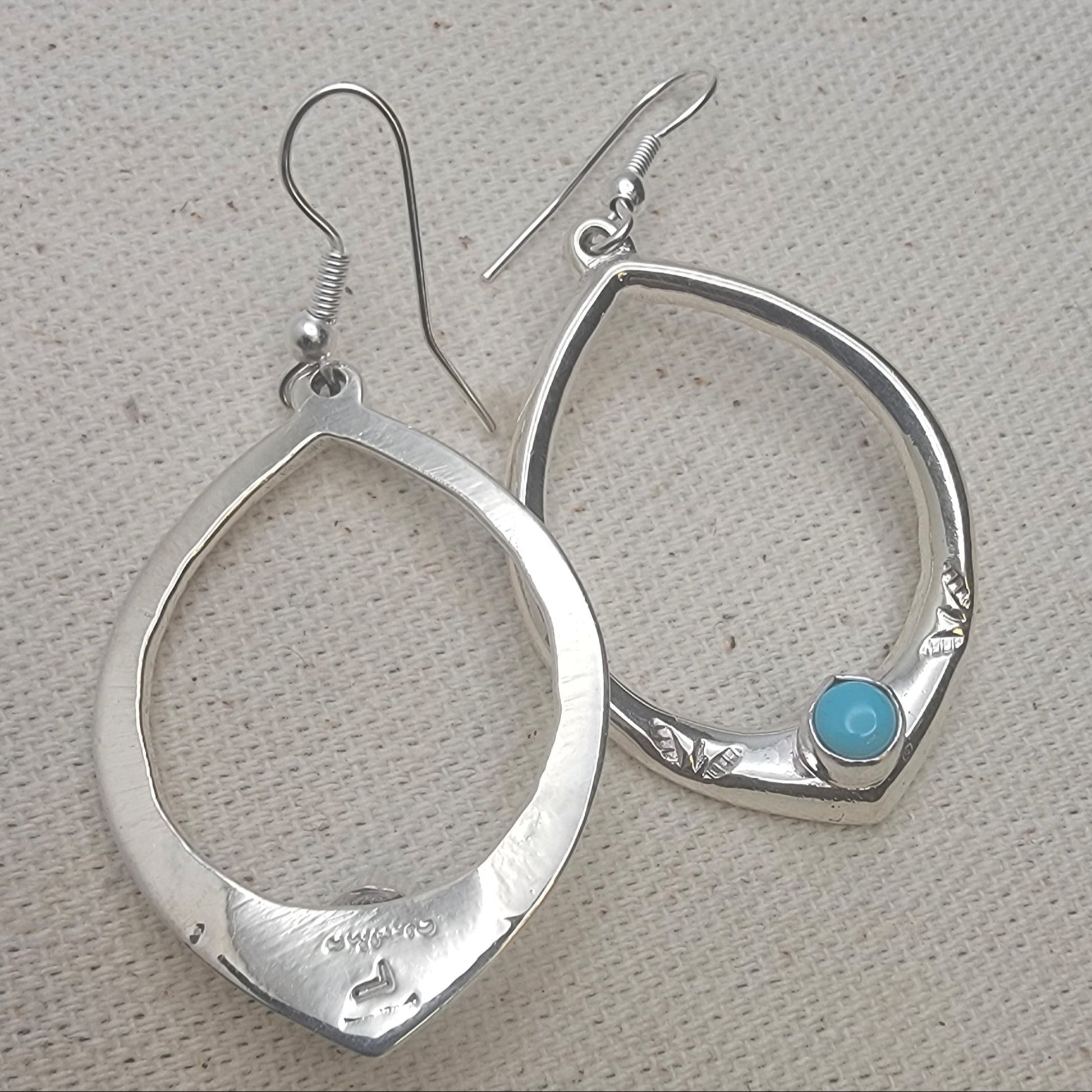 Elegant 925 Sterling Silver Teardrop Turquoise Hoop Earrings showcasing a single turquoise cabochon. This pair features a lightweight design perfect for casual jewelry, reflecting a boho chic style ideal for everyday earrings. Handcrafted with natural stone, these sterling silver earrings offer a unique touch for any outfit.