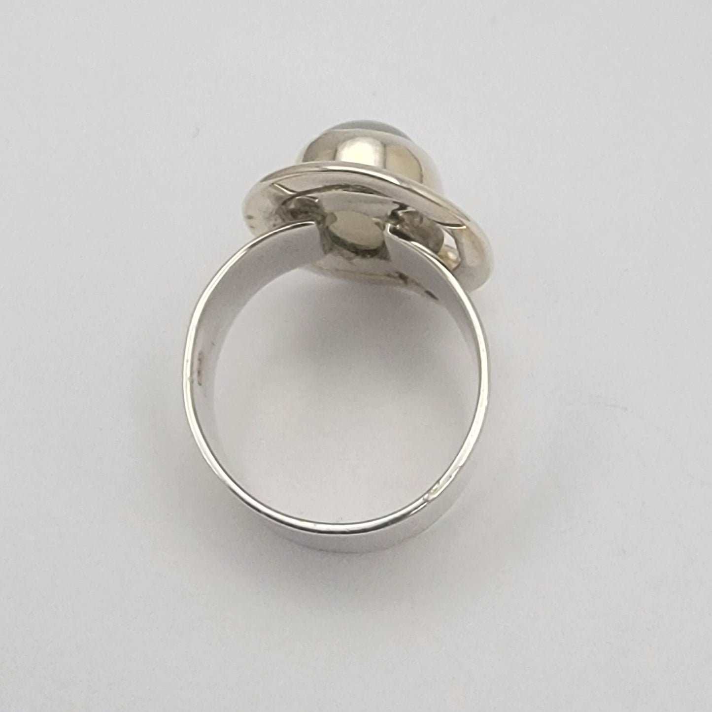 Silver ring with a gemstone on a white background