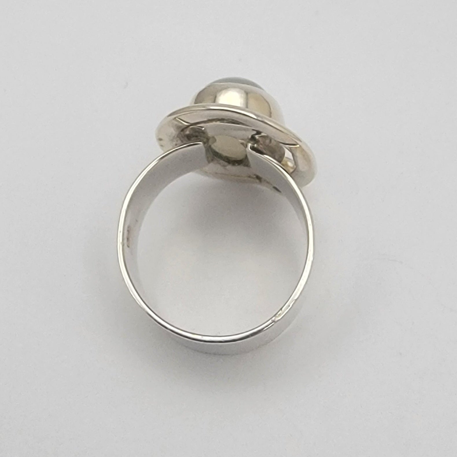 Silver ring with a gemstone on a white background