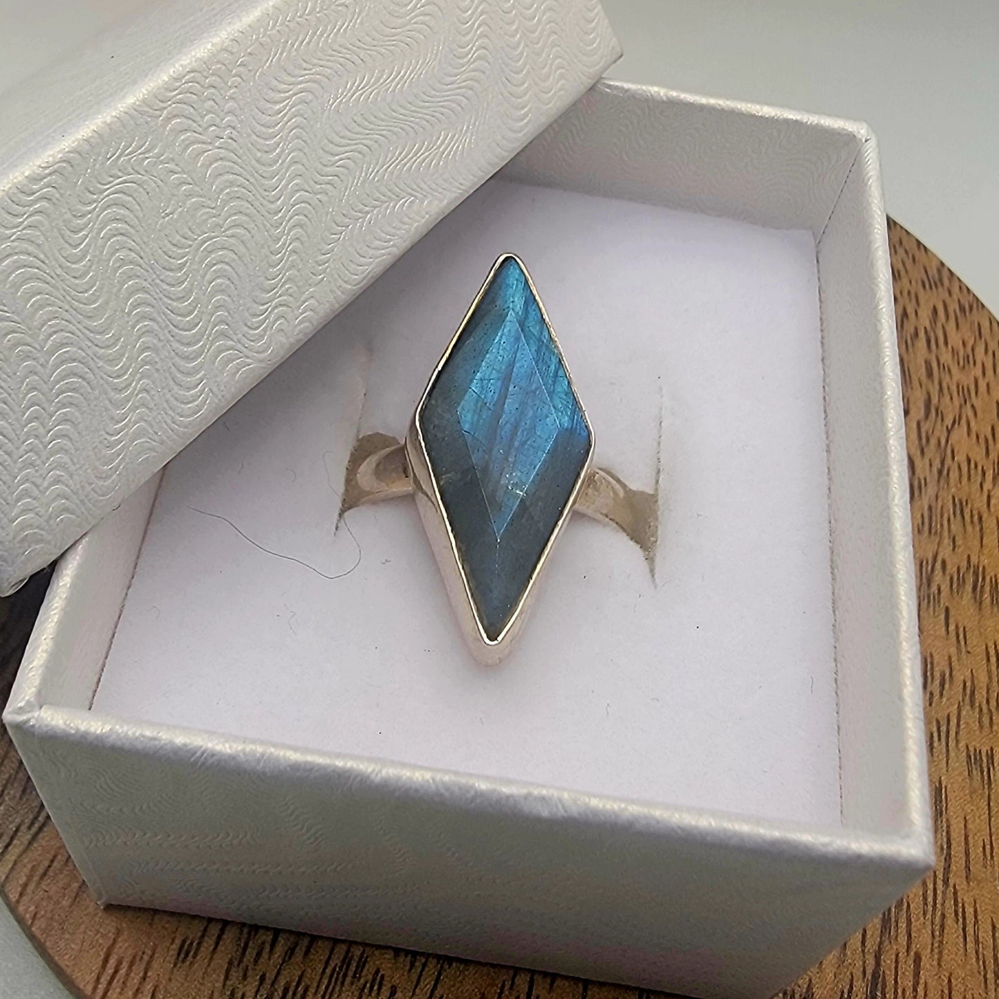 Labradorite ring in white gift box on wood background