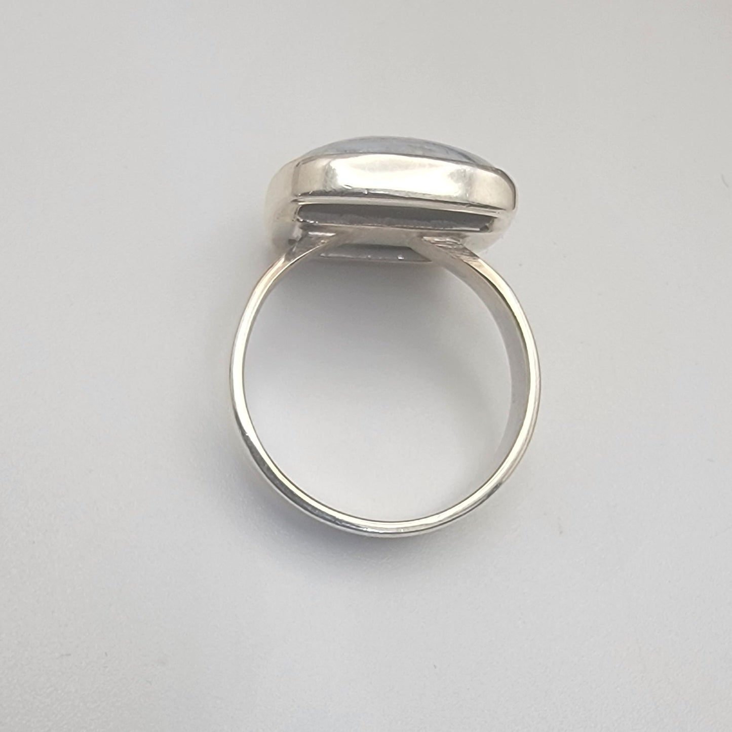 Silver ring on a light gray background