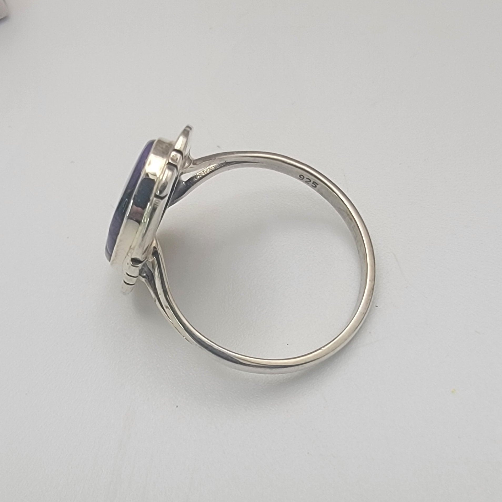 Silver ring on a light gray background