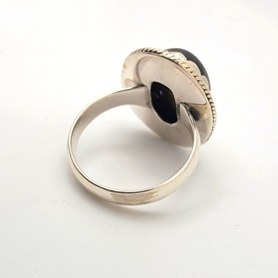 silver ring with a gemstone on a white background